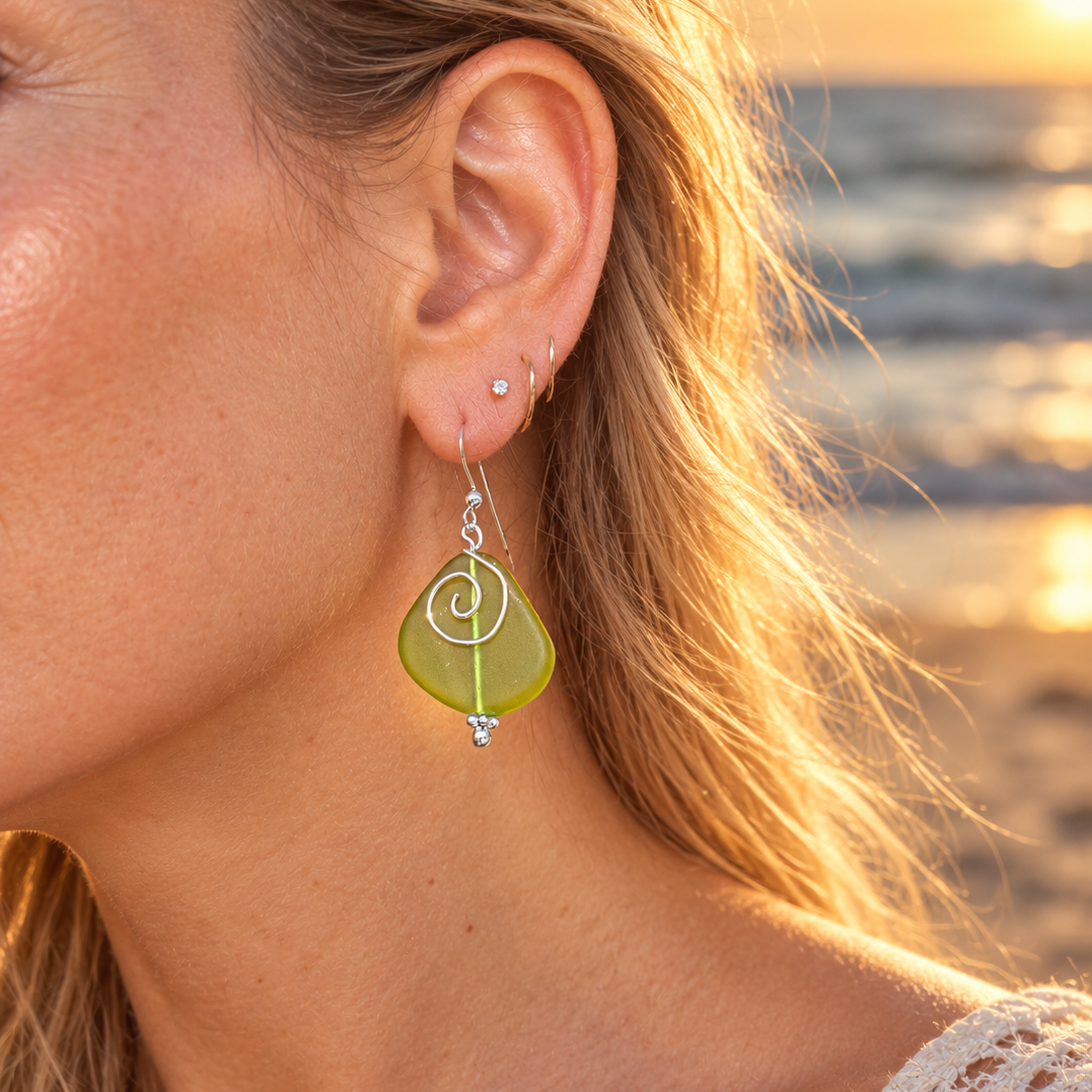 Green sea glass earrings, wire accents, and hook ear wires.