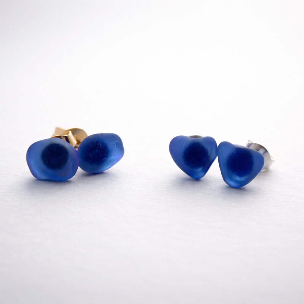 handmade cobalt blue beach glass earrings dainty stud post jewelry heart-shaped earrings on a white background